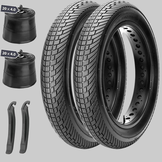 Two motorcycle tires with inner tubes and tire levers on a white background
