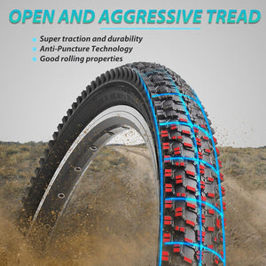 A knobby off-road bicycle tire shown at an angle outdoors on dirt, with marketing text at the top reading 'OPEN AND AGGRESSIVE TREAD' and bullet points about traction, durability, puncture resistance, and rolling properties.